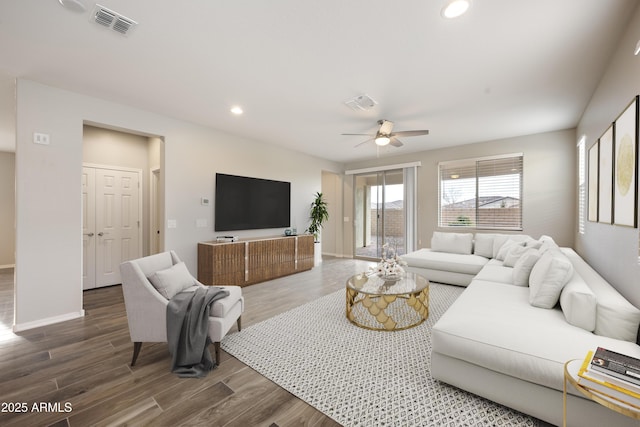 living room with wood-type flooring and ceiling fan