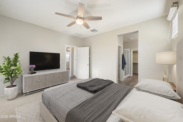 carpeted bedroom featuring a spacious closet and ceiling fan