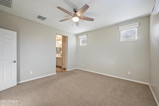 carpeted empty room featuring ceiling fan