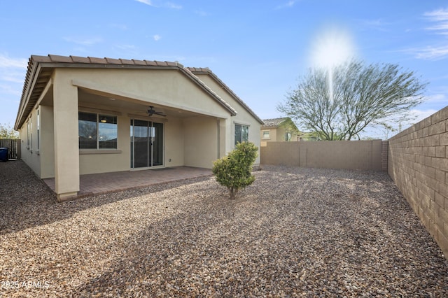 rear view of house with a patio and ceiling fan