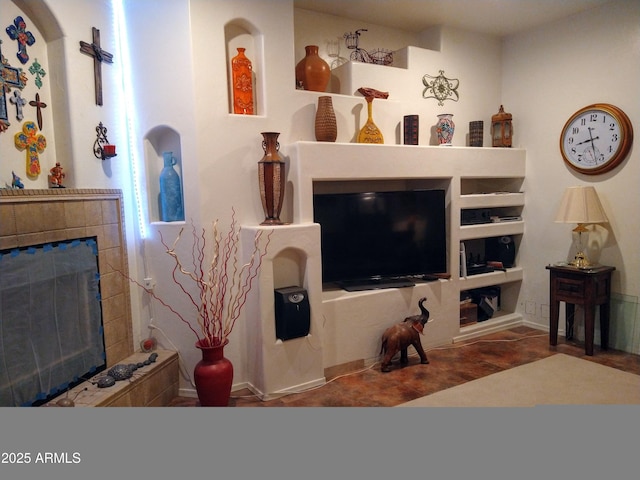 living room featuring a tile fireplace