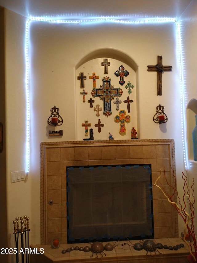 interior details with a tile fireplace