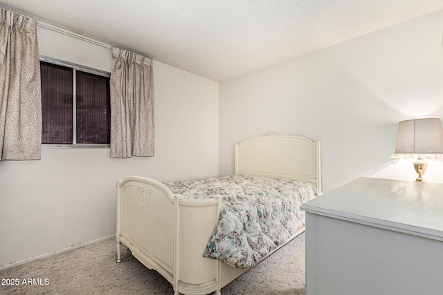 carpeted bedroom featuring a textured ceiling