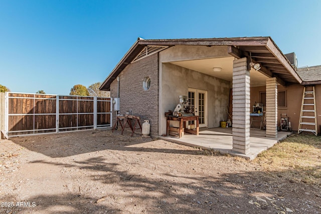 rear view of house featuring a patio and french doors