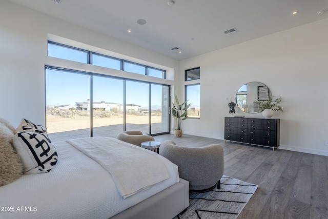23656 N 123rd St Unit 240, Scottsdale, AZ 85255 - bedroom featuring access to exterior, baseboards, visible vents, and wood finished floors