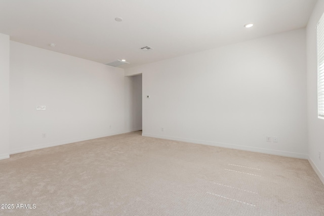 empty room featuring light carpet, visible vents, recessed lighting, and baseboards