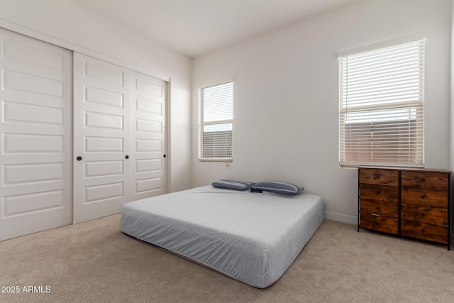 bedroom with a closet and carpet flooring