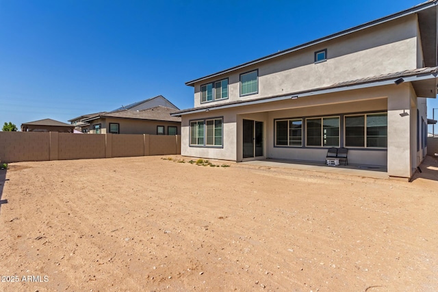 back of house with a patio, fence, and stucco siding