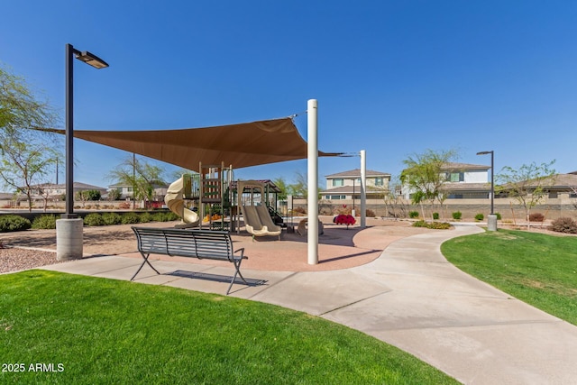 view of community featuring playground community and a lawn