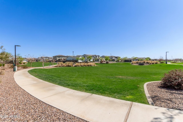 surrounding community with a residential view and a lawn