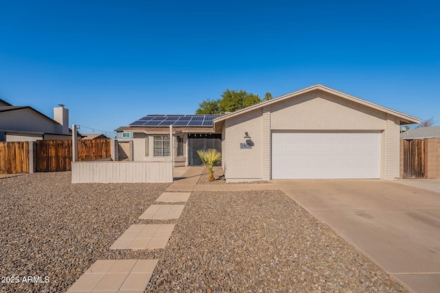 single story home featuring a garage and solar panels