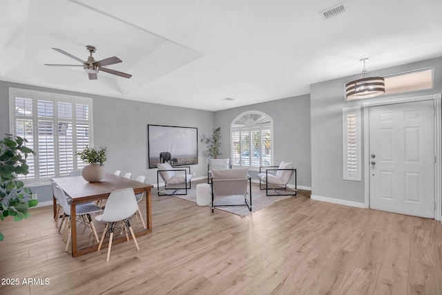 10809 W Harmony Ln, Peoria, AZ 85373 - dining area featuring a raised ceiling, visible vents, light wood-style floors, baseboards, and a ceiling fan