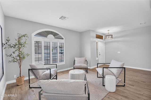 10809 W Harmony Ln, Peoria, AZ 85373 - sitting room with wood finished floors, visible vents, and baseboards