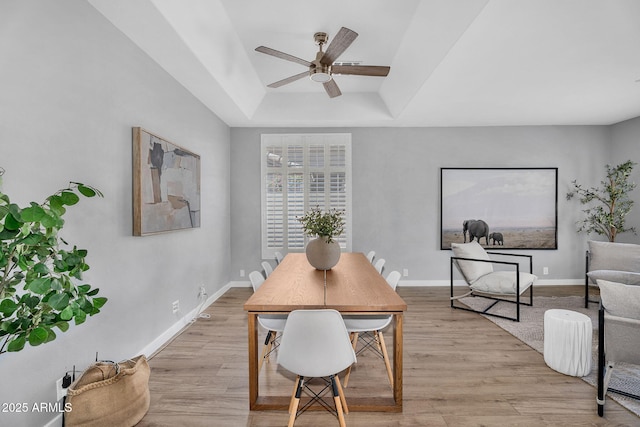 10809 W Harmony Ln, Peoria, AZ 85373 - dining area featuring ceiling fan, light wood-type flooring, a tray ceiling, and baseboards