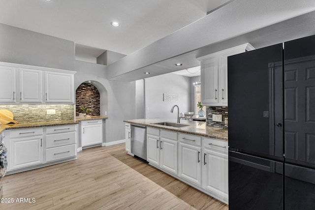 10809 W Harmony Ln, Peoria, AZ 85373 - kitchen with backsplash, dishwasher, black fridge, and a sink
