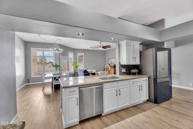 10809 W Harmony Ln, Peoria, AZ 85373 - kitchen with stainless steel appliances, baseboards, light wood finished floors, and a sink
