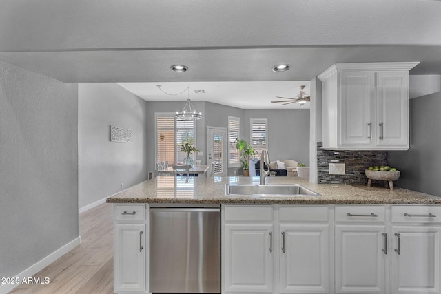 10809 W Harmony Ln, Peoria, AZ 85373 - kitchen featuring stainless steel dishwasher, white cabinets, light wood-style flooring, a sink, and baseboards