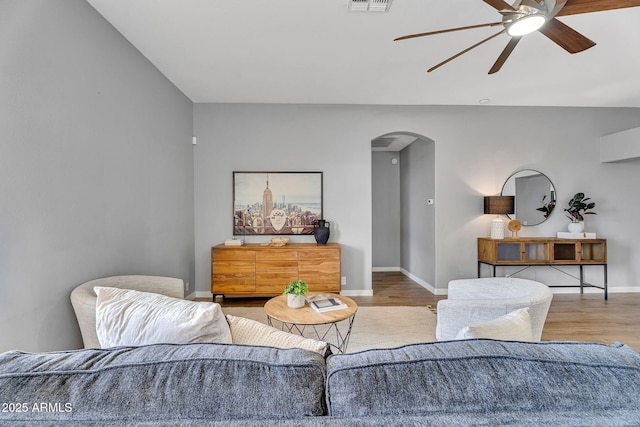 10809 W Harmony Ln, Peoria, AZ 85373 - living room featuring baseboards, arched walkways, ceiling fan, and wood finished floors