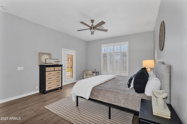 10809 W Harmony Ln, Peoria, AZ 85373 - bedroom featuring access to exterior, a ceiling fan, wood finished floors, and baseboards