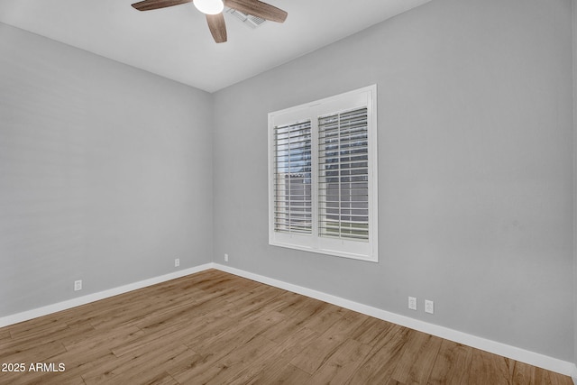 10809 W Harmony Ln, Peoria, AZ 85373 - spare room featuring wood finished floors, ceiling fan, and baseboards