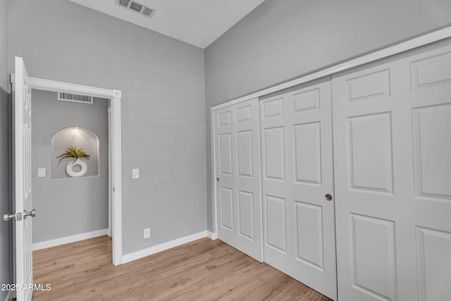10809 W Harmony Ln, Peoria, AZ 85373 - unfurnished bedroom with visible vents, baseboards, light wood finished floors, and a closet