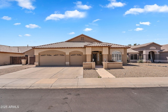 10809 W Harmony Ln, Peoria, AZ 85373 - mediterranean / spanish-style house with concrete driveway, an attached garage, a tiled roof, and stucco siding