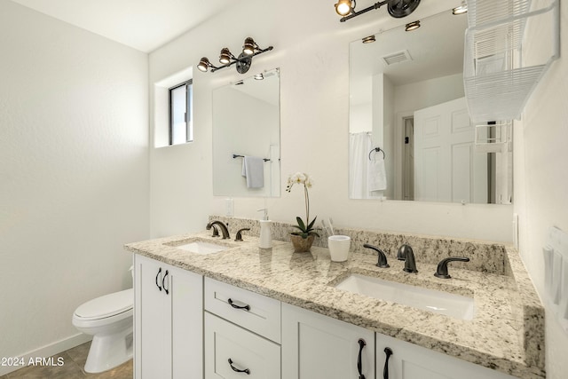 bathroom featuring tile patterned flooring, vanity, and toilet