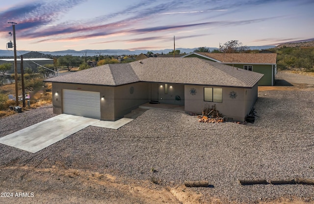 ranch-style home with a mountain view and a garage