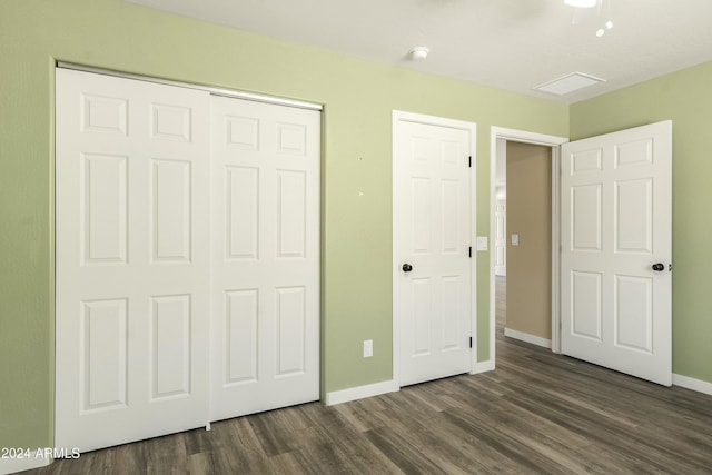 unfurnished bedroom featuring ceiling fan and dark wood-type flooring