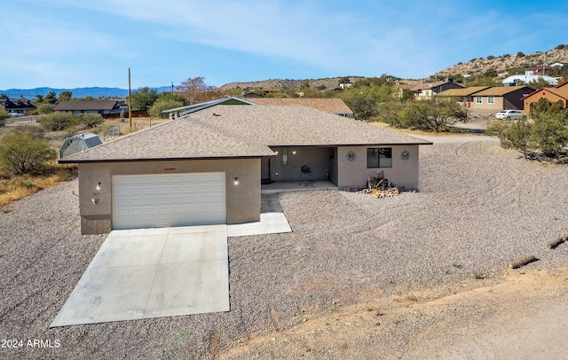 ranch-style house featuring a mountain view and a garage