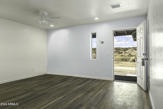 interior space with ceiling fan and dark hardwood / wood-style flooring