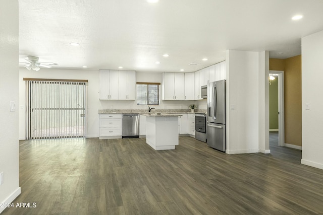 kitchen with a center island, white cabinetry, and stainless steel appliances