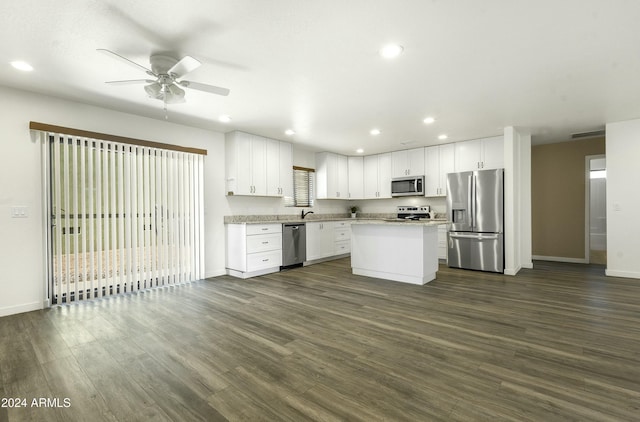 kitchen featuring ceiling fan, white cabinetry, dark hardwood / wood-style flooring, a kitchen island, and appliances with stainless steel finishes