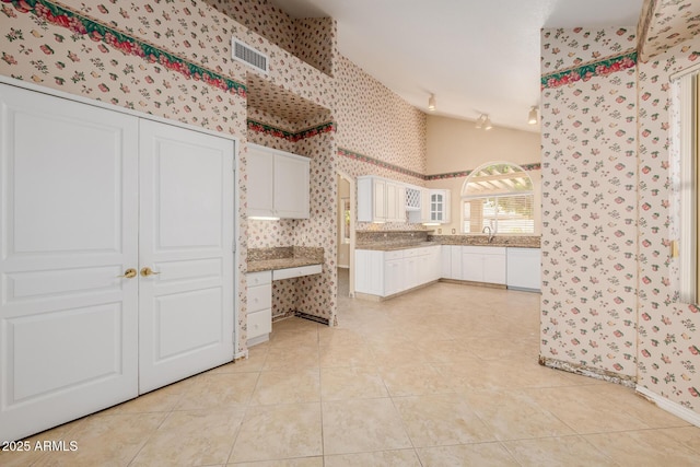 728 W Sandra Ter, Phoenix, AZ 85023 - kitchen featuring wallpapered walls, light tile patterned flooring, white cabinets, glass insert cabinets, and dishwasher