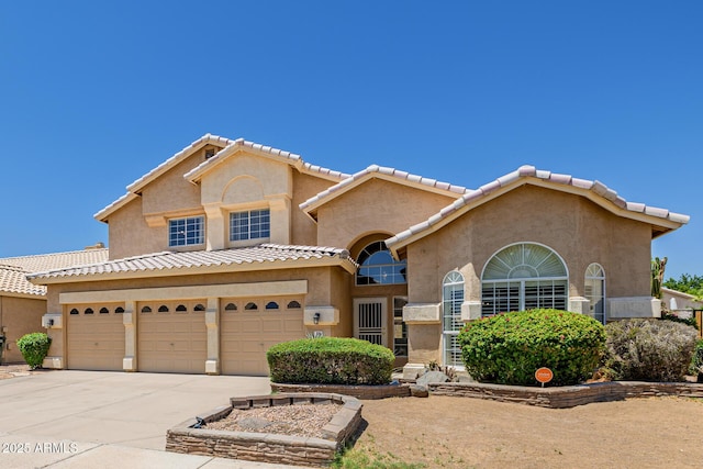 728 W Sandra Ter, Phoenix, AZ 85023 - view of front facade with concrete driveway, stucco siding, a tiled roof, and a garage