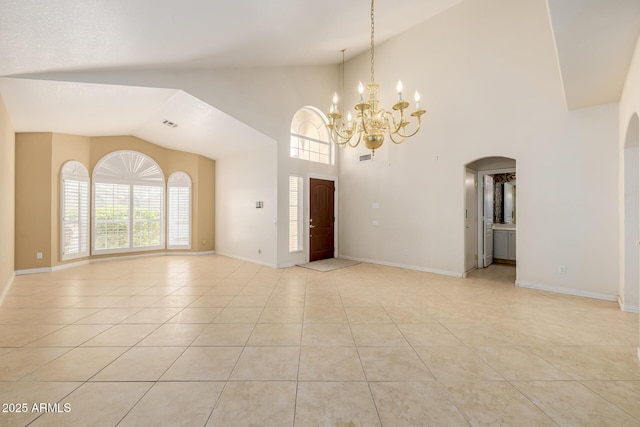 728 W Sandra Ter, Phoenix, AZ 85023 - unfurnished living room featuring arched walkways, vaulted ceiling, a chandelier, and light tile patterned flooring