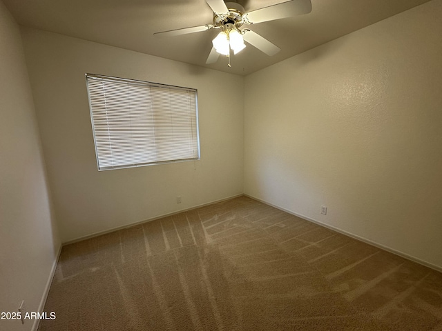 empty room featuring carpet floors, baseboards, and a ceiling fan