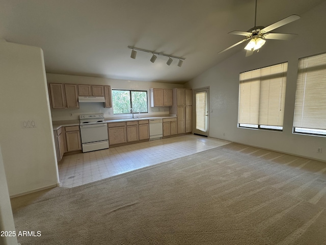 kitchen featuring light countertops, light colored carpet, light brown cabinets, white appliances, and under cabinet range hood