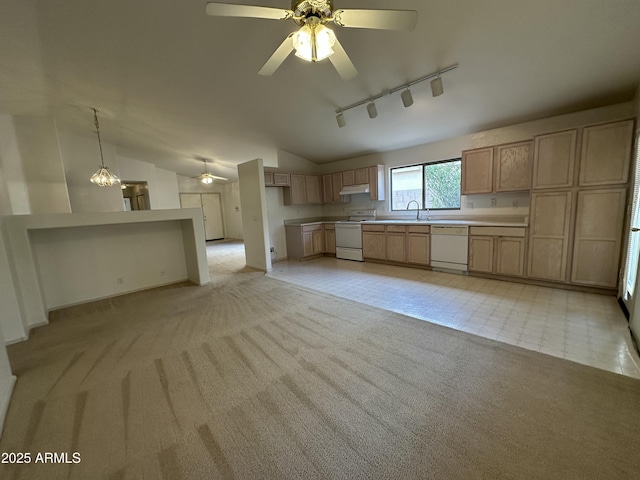 kitchen featuring light carpet, white appliances, vaulted ceiling, and a sink