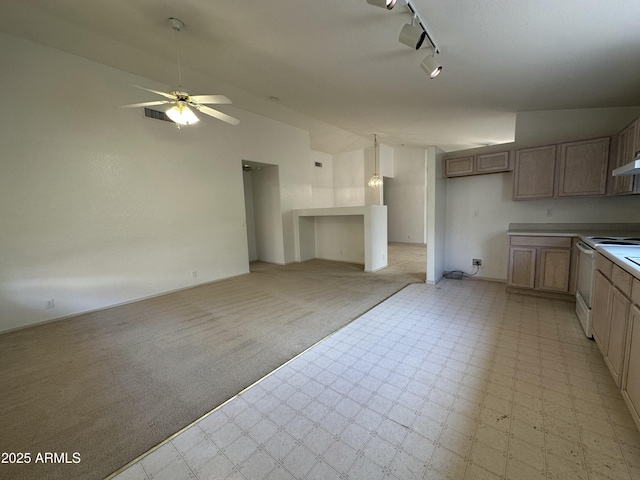 kitchen featuring electric stove, light floors, rail lighting, vaulted ceiling, and ceiling fan