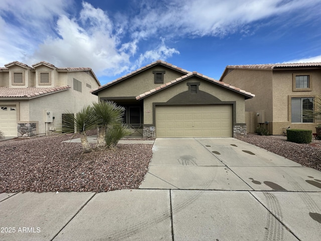 view of front facade with a garage, concrete driveway, a tiled roof, and stucco siding