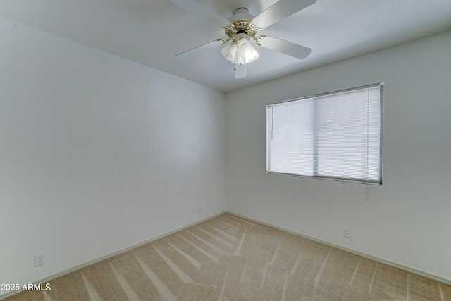 unfurnished room with a ceiling fan and light colored carpet