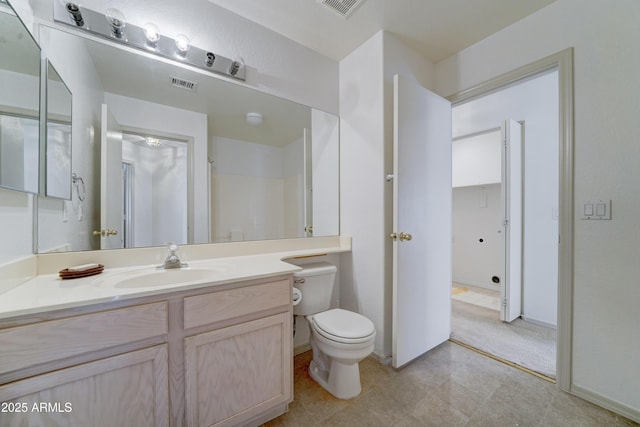 bathroom featuring toilet, visible vents, and vanity