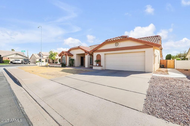 mediterranean / spanish-style house with a garage