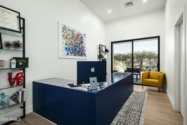 office space with recessed lighting, visible vents, baseboards, and wood finished floors