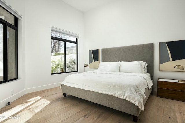 bedroom featuring baseboards and wood finished floors