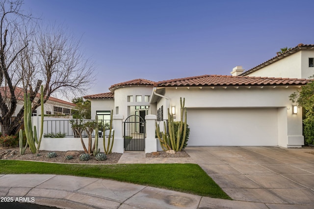 mediterranean / spanish-style home with stucco siding, a gate, fence, a garage, and driveway