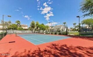 view of tennis court featuring fence