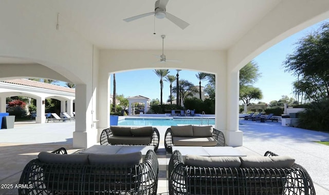 view of patio / terrace featuring ceiling fan, a community pool, and an outdoor hangout area