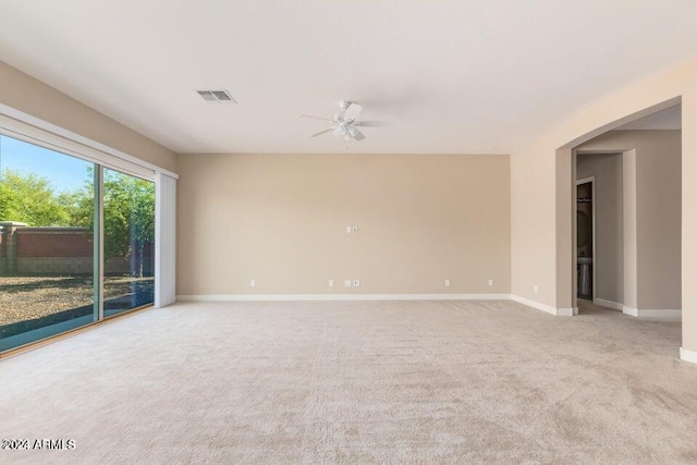 carpeted empty room featuring ceiling fan